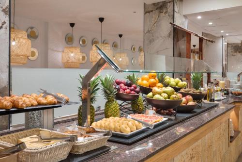 a buffet with many different types of fruits and vegetables at Valentin Somni Hotel & Suites in Paguera