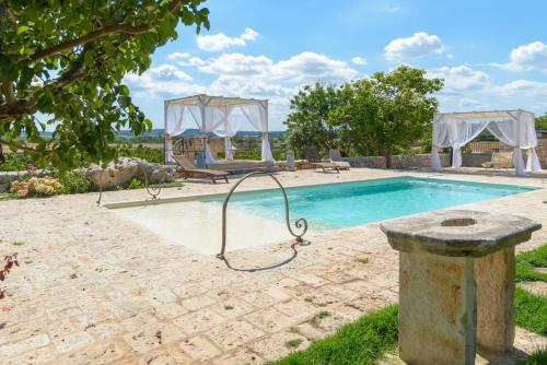 a swimming pool with a swing in a yard at La Maison - Tenuta Colavecchio in Putignano
