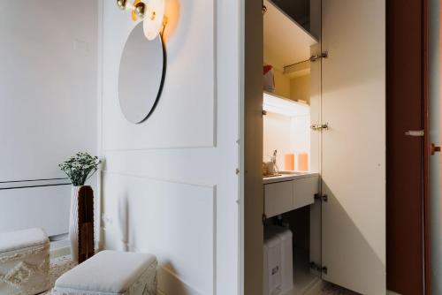 a bathroom with a mirror and a sink at Palazzo D'Azeglio in Alberobello