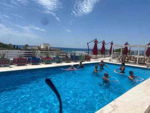 a group of people in a swimming pool at Hotel La Residence Hammamet in Hammamet