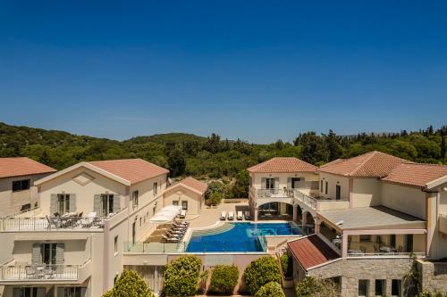 an aerial view of a house with a swimming pool at Belle View Hotel - Sea View & Sunset in Mánganos