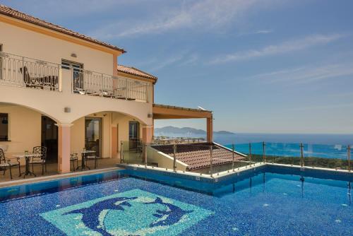 a villa with a swimming pool with a view of the ocean at Belle View Hotel - Sea View & Sunset in Mánganos