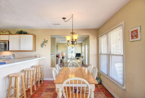 a kitchen and dining room with a table and chairs at Helmstetler #3B in Topsail Beach