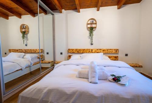 a bedroom with two beds with white sheets at Private Pool Retreat - Georgia's Garden Oasis in Alónia