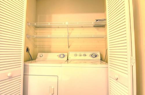 a washer and dryer in a small closet at Helmstetler #3B in Topsail Beach