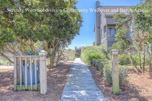 a walkway in front of a house with a fence at Helmstetler #3B in Topsail Beach