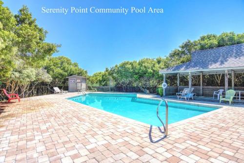 a swimming pool in a yard with a house at Helmstetler #3B in Topsail Beach