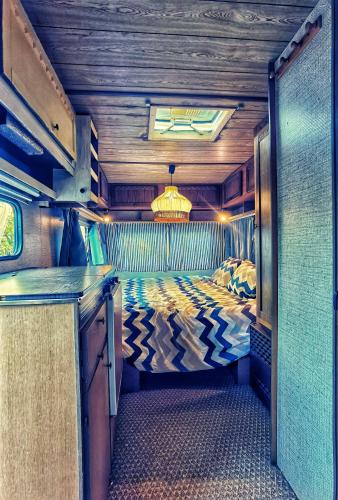 a bedroom in an rv with a bed in it at Caravan of Love by Casa das Artes in Luz de Tavira