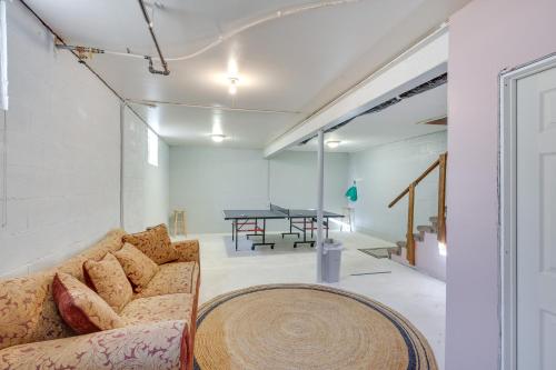 a living room with a couch and a table at Charming Farmington Home about 16 Mi to Aztec Ruins! in Farmington