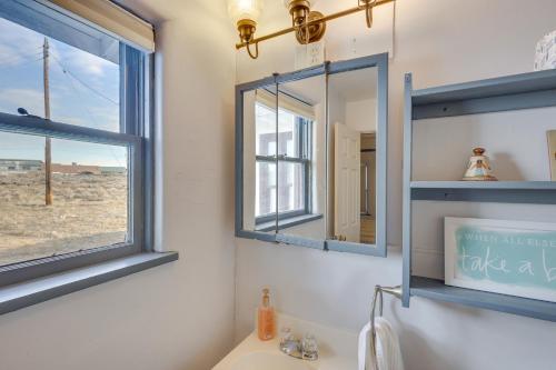 a bathroom with two mirrors and a sink at Charming Farmington Home about 16 Mi to Aztec Ruins! in Farmington