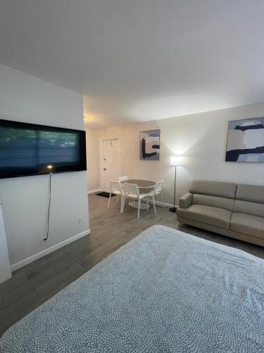 a living room with a couch and a table at City First Story Apartments & Cottage in Fort Lauderdale
