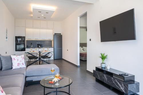 a living room with a couch and a table at PNOẼ Luxury Apartments in Lourdhata