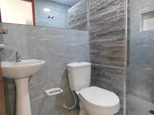 a bathroom with a toilet and a sink at El Velero Apartamentos By DANP in Santa Marta