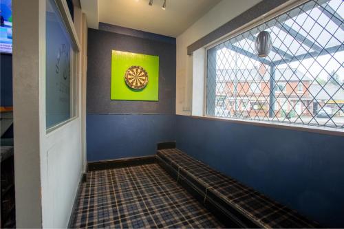 a waiting room with a bench and a clock on the wall at The Midland Hotel in Leeds