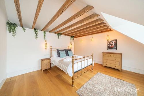 a bedroom with a bed and a wooden ceiling at Kirkton Family Farmhouse with Hot Tub, Alford, Aberdeenshire in Alford
