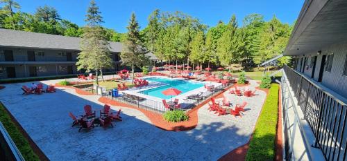 an overhead view of a pool with tables and chairs at The Stone Gate Resort in Lake George