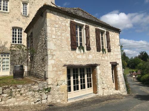 an old stone building with a door and windows at Logis de Chaumiac in Bouniagues