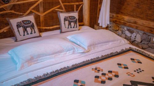 a bed with two pillows on top of it at 张家界竹奢民宿 in Zhangjiajie