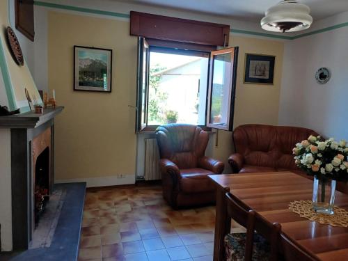 a living room with two chairs and a fireplace at Relax nella Natura, Casa Vacanze con Vista in Toscana in Sestino