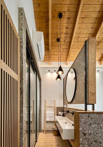 a bathroom with a sink and a mirror at Villa Vrachos luxury Living in Vrachos