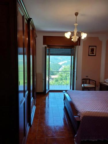 a bedroom with a bed and a window with a view at Dalla Nonna Ida, Casa Vacanze con Vista in Toscana in Sestino