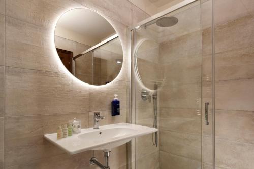 a bathroom with a sink and a mirror at FH55 Hotel Villa Fiesole in Fiesole