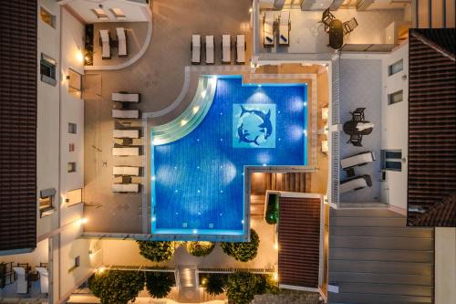 an overhead view of a swimming pool in a building at Belle View Hotel - Sea View & Sunset in Mánganos