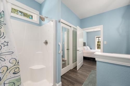 a bathroom with blue walls and a walk in shower at Voyage Anchor in Nags Head