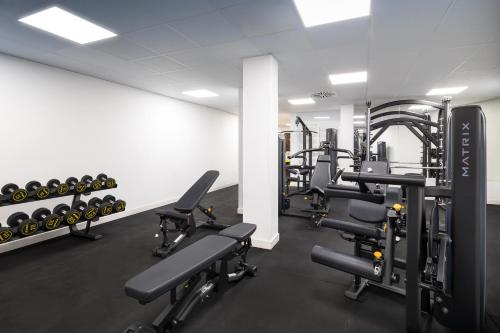 a gym with rows of treadmills and weights at Barceló Tenerife in San Miguel de Abona