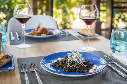 a table with plates of food and glasses of wine at Barceló Tenerife in San Miguel de Abona