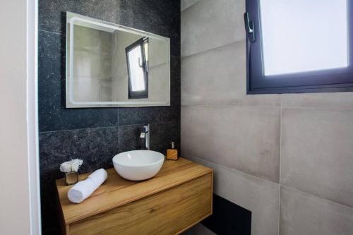 a bathroom with a sink and a mirror at Pena View Villa in Santa Cruz
