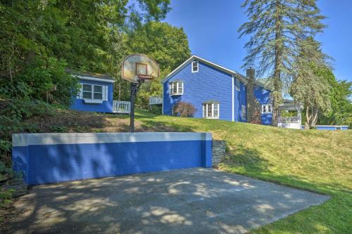 a blue house with a basketball hoop in the yard at Montour Falls Home 2 Mi to Seneca Lake and Wineries in Montour Falls