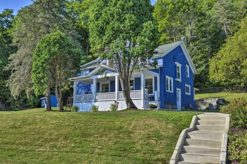 a blue house with a tree in the yard at Montour Falls Home 2 Mi to Seneca Lake and Wineries in Montour Falls
