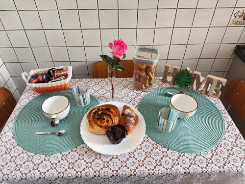 a table with a plate of food on a table at Guest House Montebello in Asti