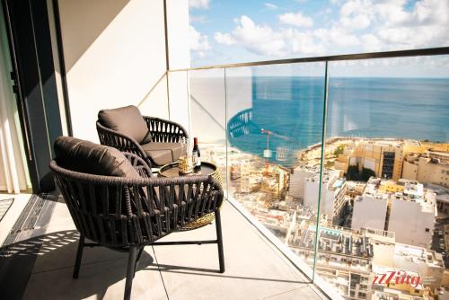 a balcony with two chairs and a table on a building at Exclusive Luxury at Mercury Towers in St Julian's