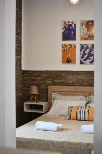 a bedroom with a bed with two pillows on it at Athena's Archontiko Master Floor in Andros