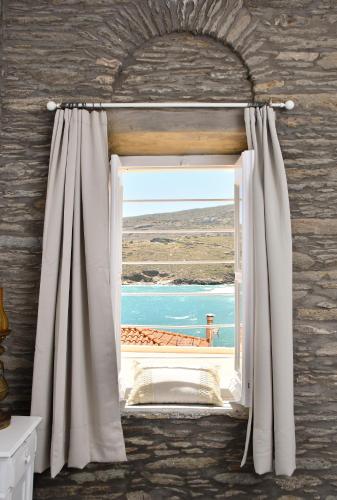 an open window with a view of the ocean at Athena's Archontiko Master Floor in Andros