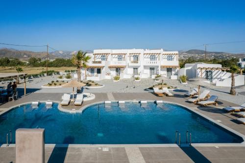 a large swimming pool in front of a building at Naxos Finest Hotel & Villas in Naxos Chora