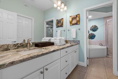 a bathroom with a large sink and a tub at San Carlos 401 in Gulf Shores
