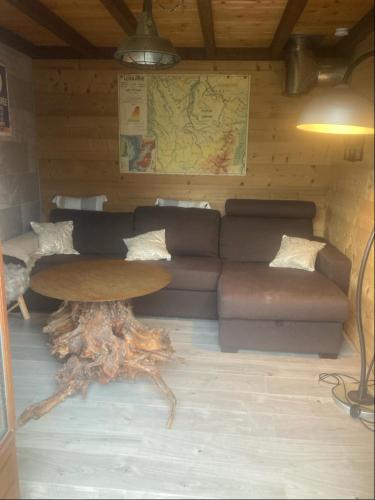 a living room with a couch and a table at Chalet L'envolée Bleue in Xonrupt-Longemer