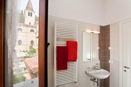 a bathroom with a sink and a mirror and a window at B&B Borgo Castello in Marostica