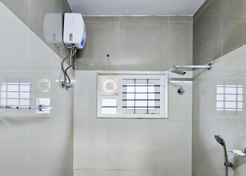 a bathroom with a shower and a window at Villa Espoir By Alchemy Homes in Ernakulam