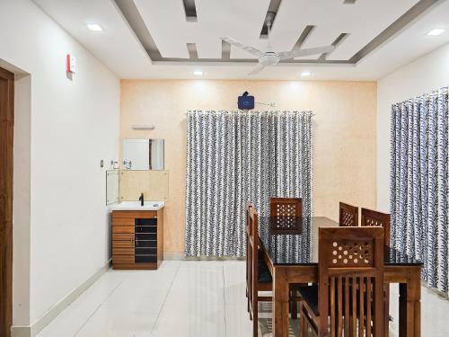a dining room with a table and chairs at Villa Espoir By Alchemy Homes in Ernakulam