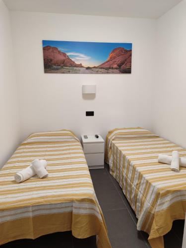two beds in a room with red mountains at Casa Rica in Puerto Rico de Gran Canaria