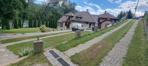 a van is parked in front of a house at Apartmani Kriva Drina in Okletac