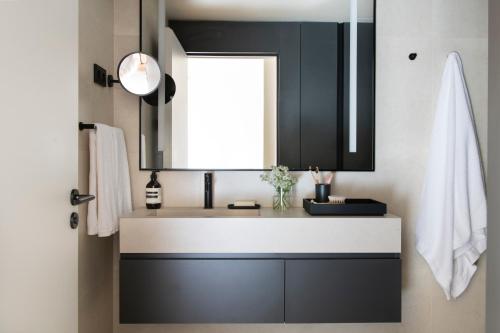a bathroom with a sink and a mirror at Archie Living in Barcelona