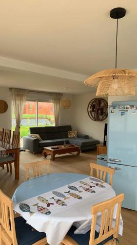 un salon avec une table et un réfrigérateur dans l'établissement La Perle du Littoral, à Étaples
