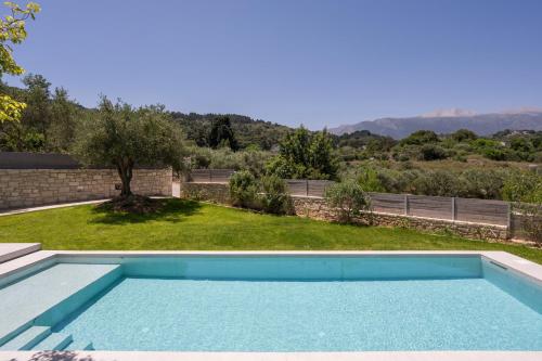 a swimming pool in the backyard of a house at VILLA PETRA PHILIPPOS heated pool optional in Khámbatha