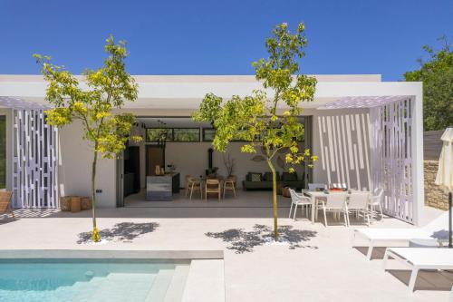 a courtyard with a pool and a house at VILLA PETRA PHILIPPOS heated pool optional in Khámbatha