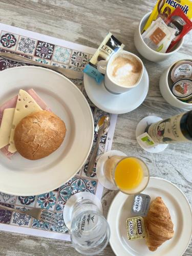 a table with plates of food and a cup of coffee at Hotel Rural Cazorla Posada del Cordobés in Cazorla